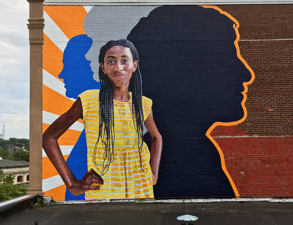 Profiles in Courage Mural painted by Bonnie Lee Turner and Charles C. Clear III on the exterior of Beacon Carter School in Woonsocket, RI